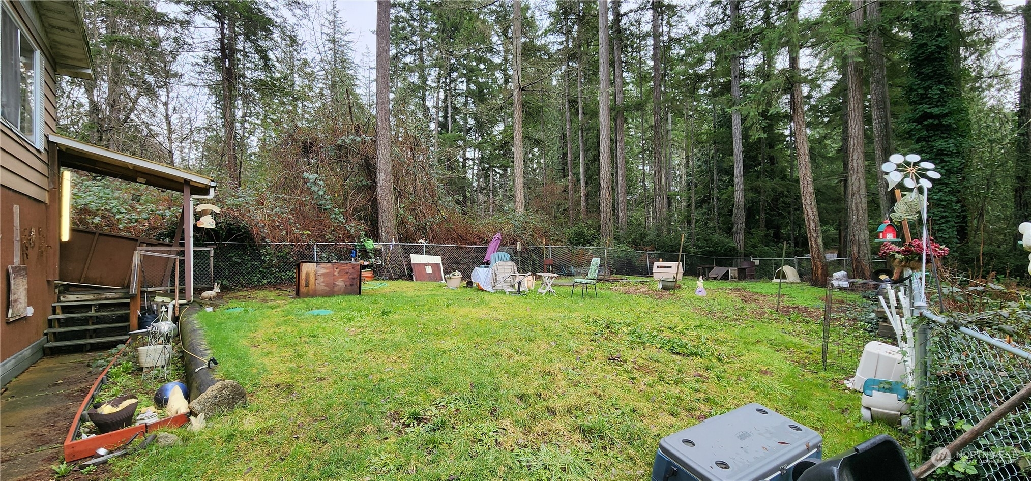 91 Maple Street Quilcene, WA 98376 - Photo 13 of 14 a backyard of a house with table and chairs