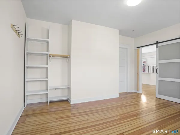 a view of a room with wooden floor