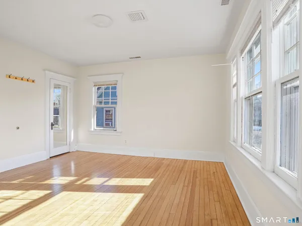 a view of a room with wooden floor and windows