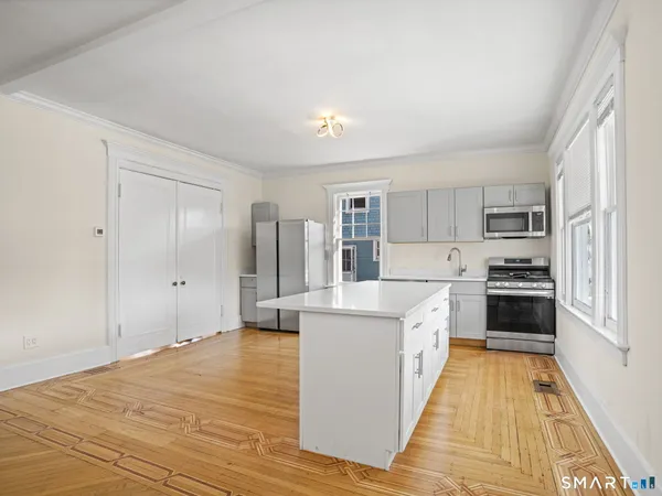 a large kitchen with cabinets and stainless steel appliances