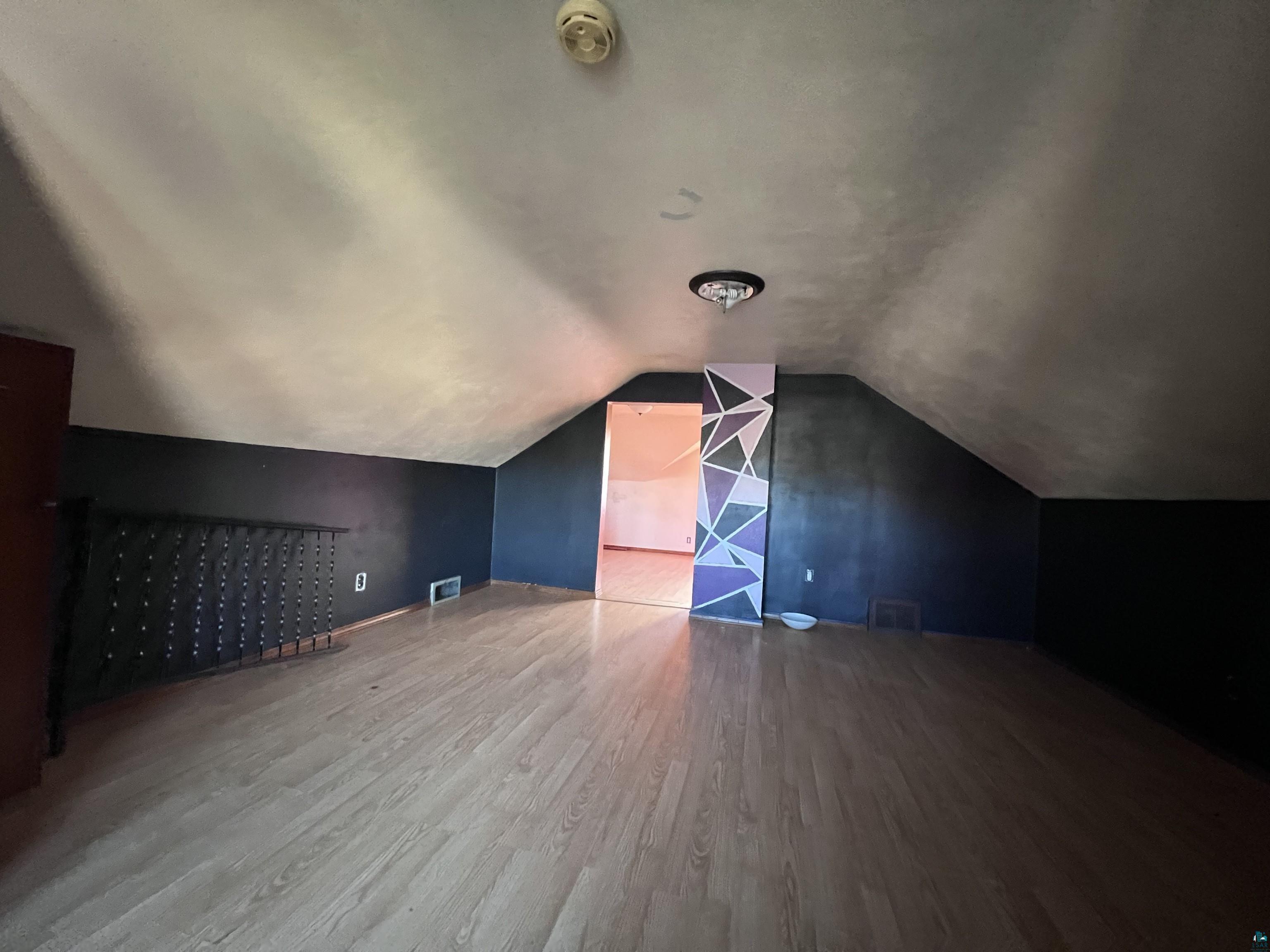 4207 East 3rd Street Superior, WI 54880 - Photo 11 of 23 Bonus room featuring hardwood / wood-style flooring and lofted ceiling