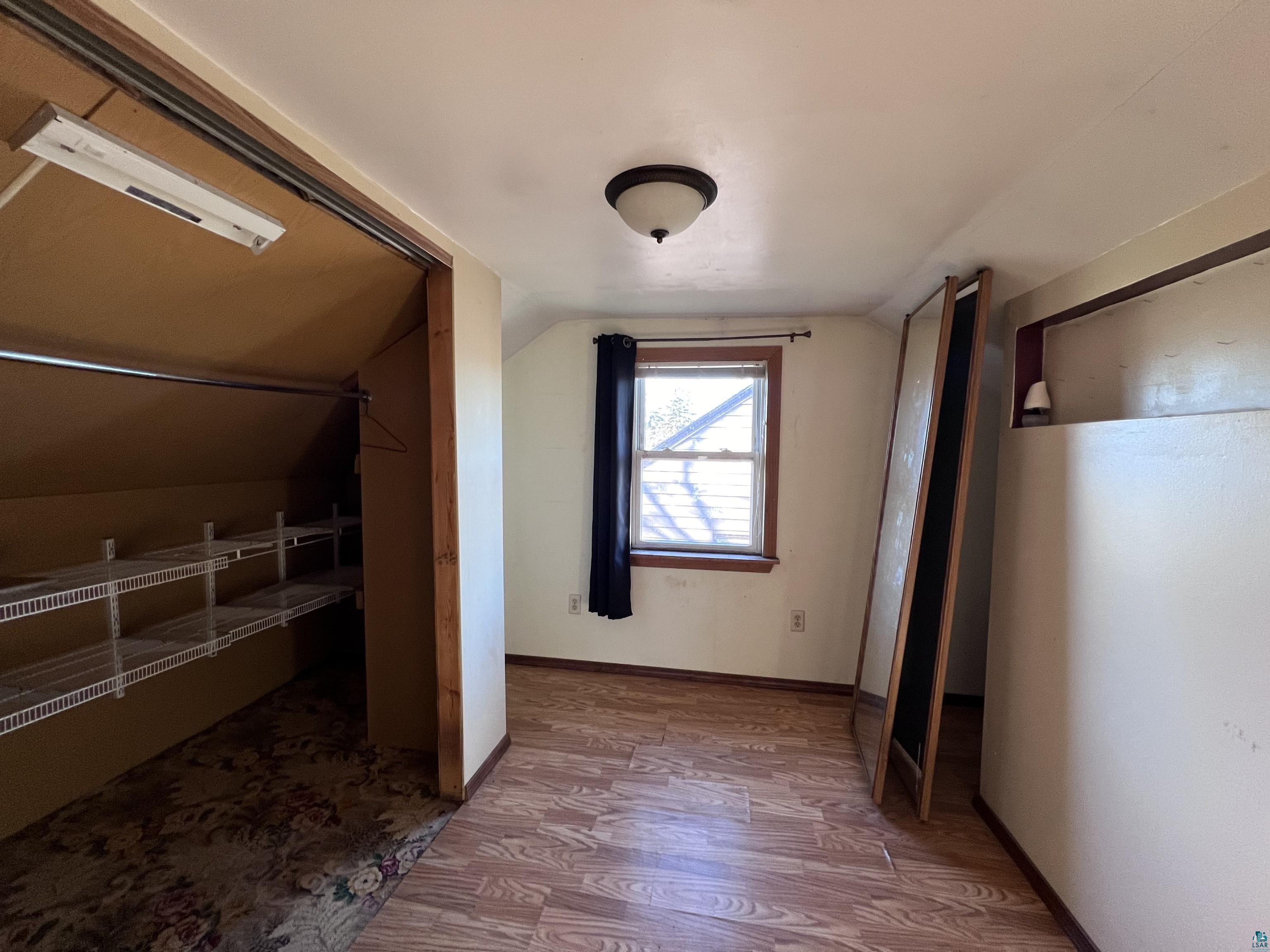 4207 East 3rd Street Superior, WI 54880 - Photo 13 of 23 Additional living space featuring hardwood / wood-style flooring and lofted ceiling