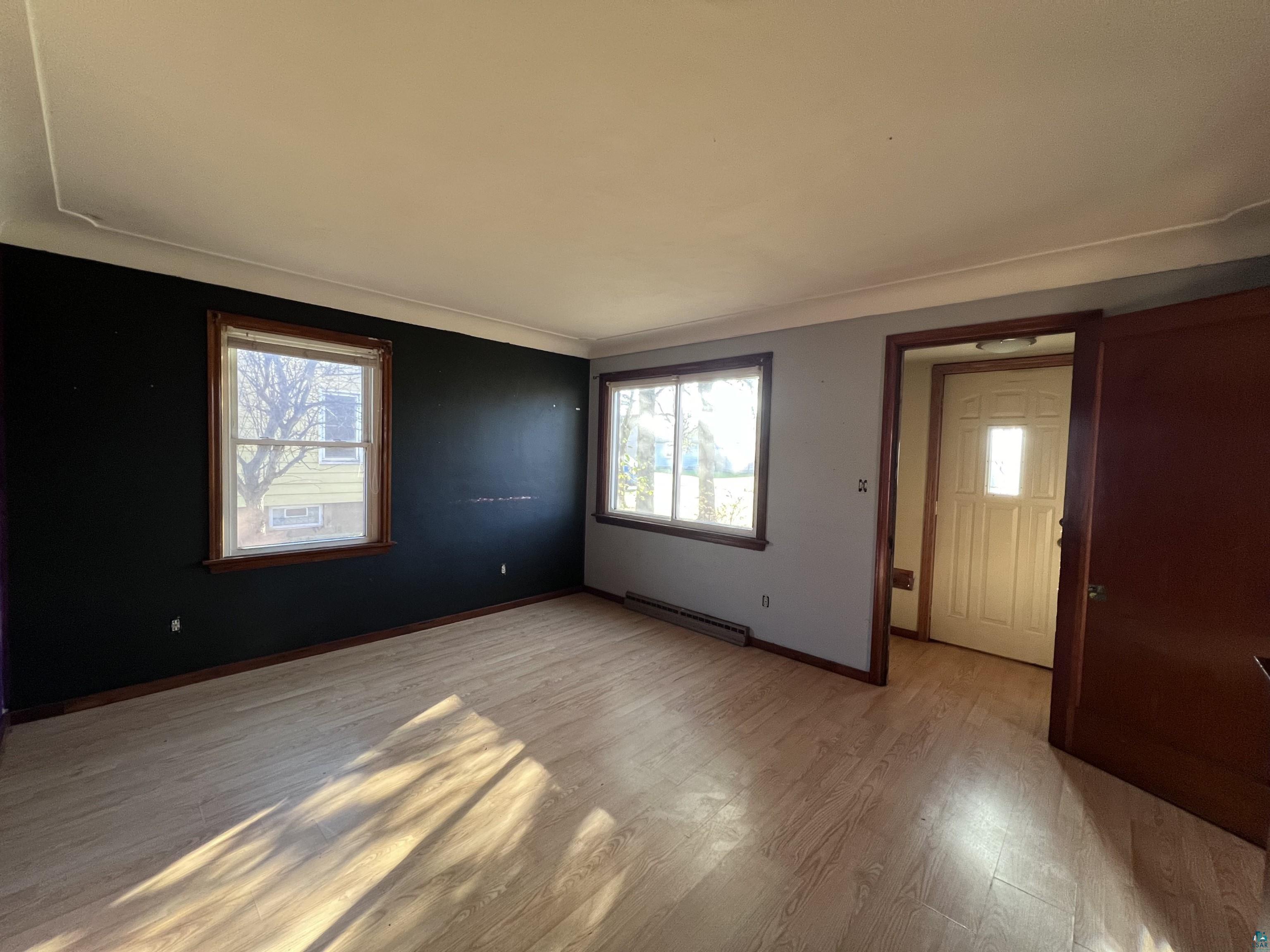 4207 East 3rd Street Superior, WI 54880 - Photo 2 of 23 Entrance foyer featuring plenty of natural light, light hardwood / wood-style floors, and a baseboard heating unit