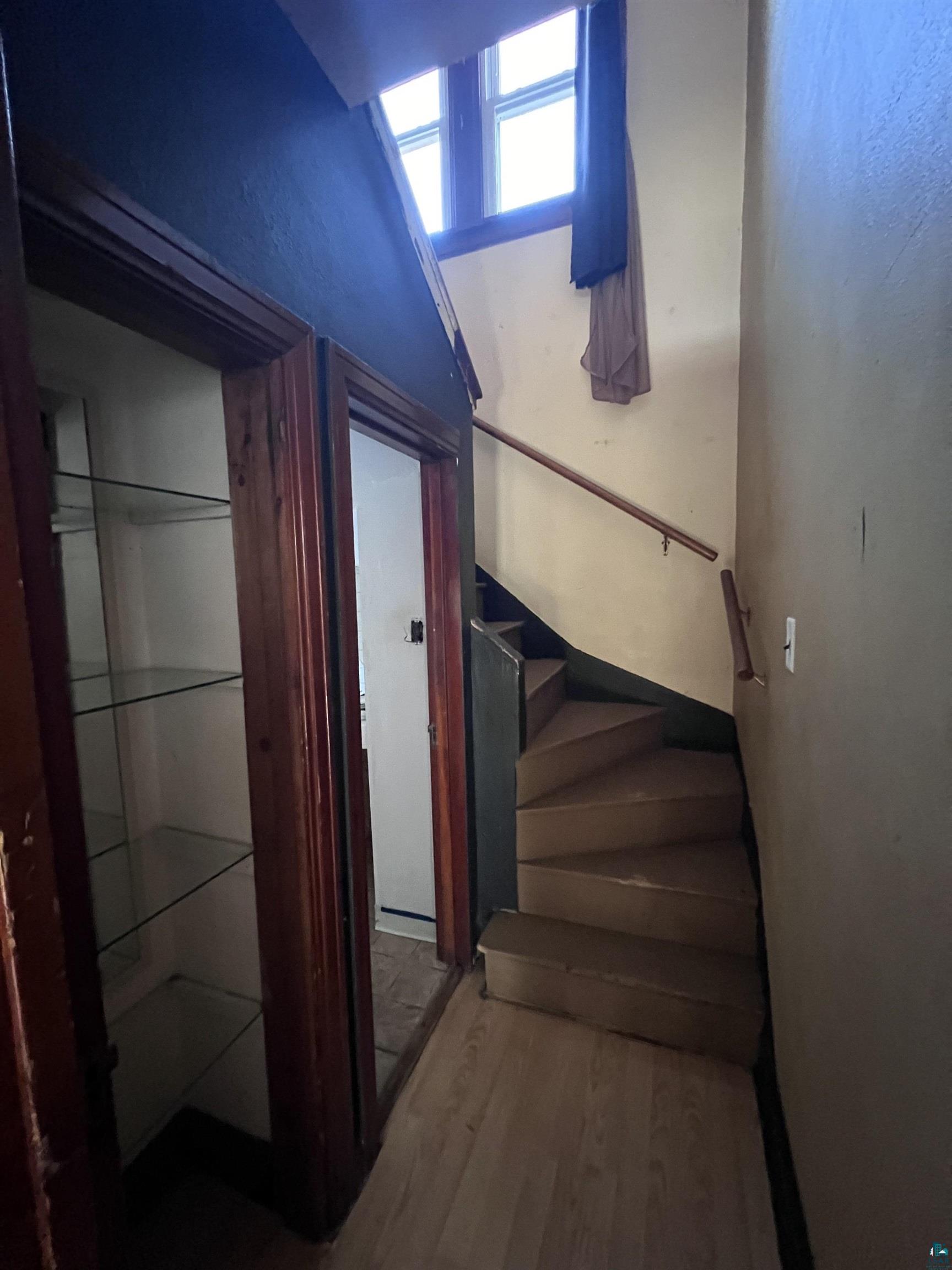 4207 East 3rd Street Superior, WI 54880 - Photo 8 of 23 Stairway featuring hardwood / wood-style flooring