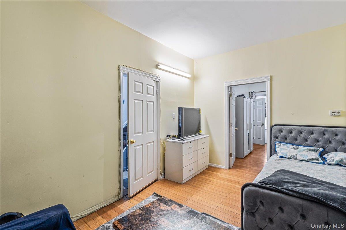 89-21 129th Street Queens, NY 11418 - Photo 13 of 19 a bedroom with furniture and wooden floor