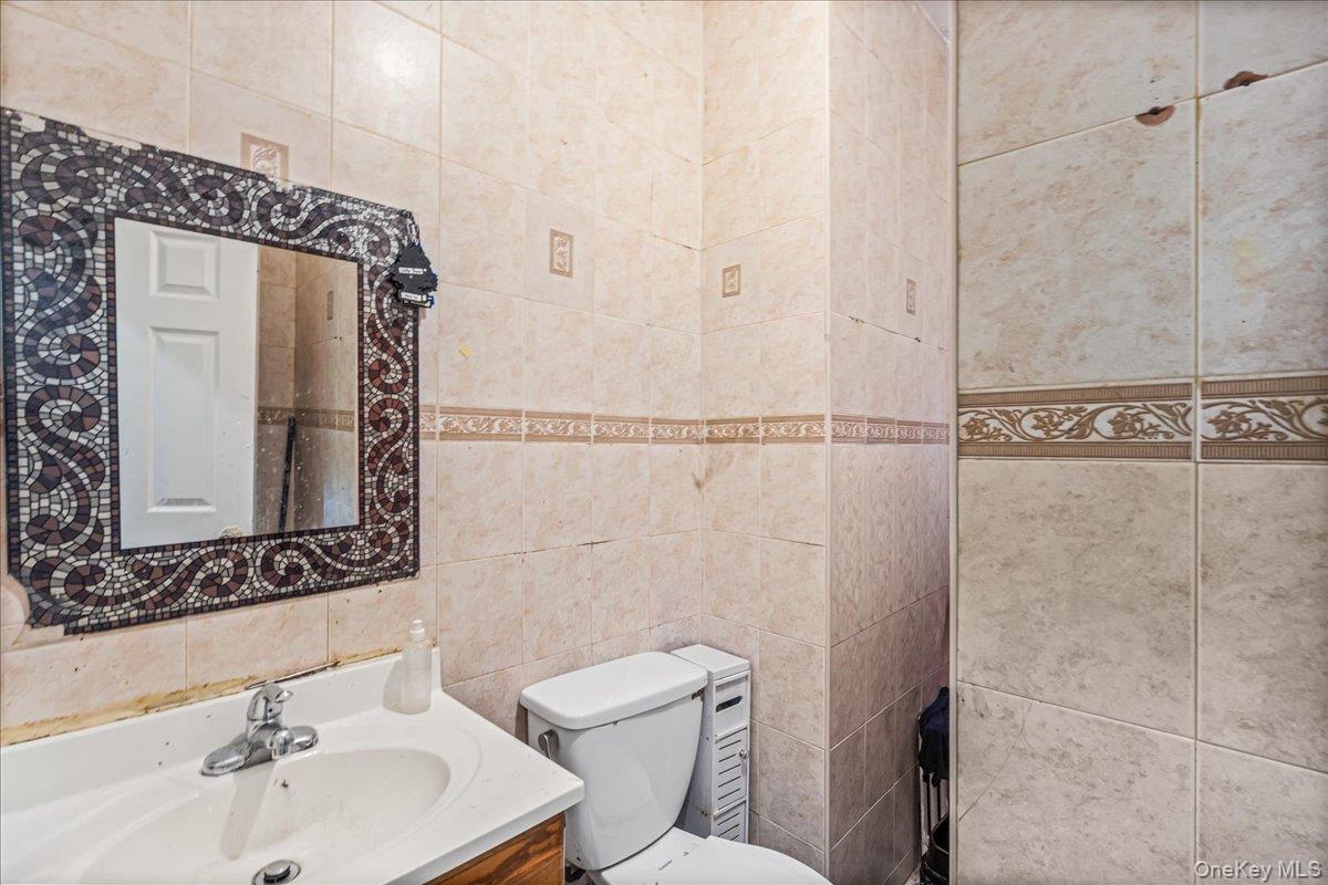 89-21 129th Street Queens, NY 11418 - Photo 17 of 19 a bathroom with a sink a toilet and shower