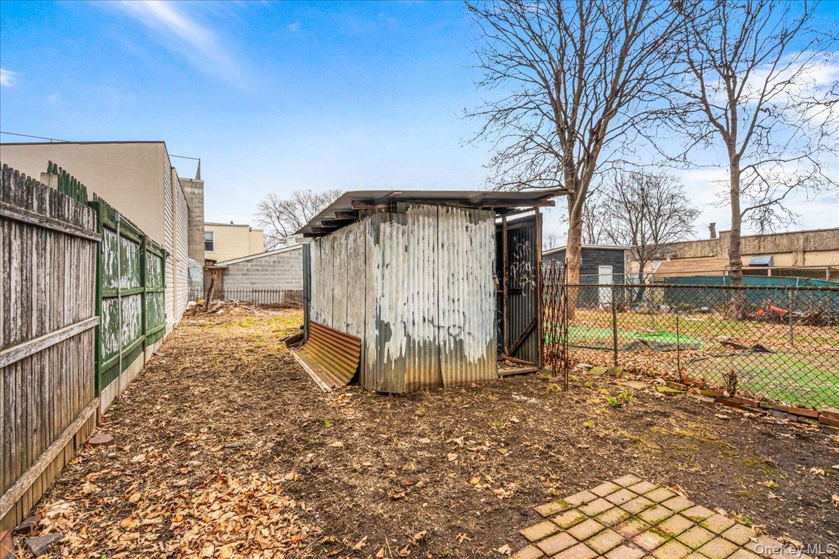 89-21 129th Street Queens, NY 11418 - Photo 5 of 19 a view of a house with a yard