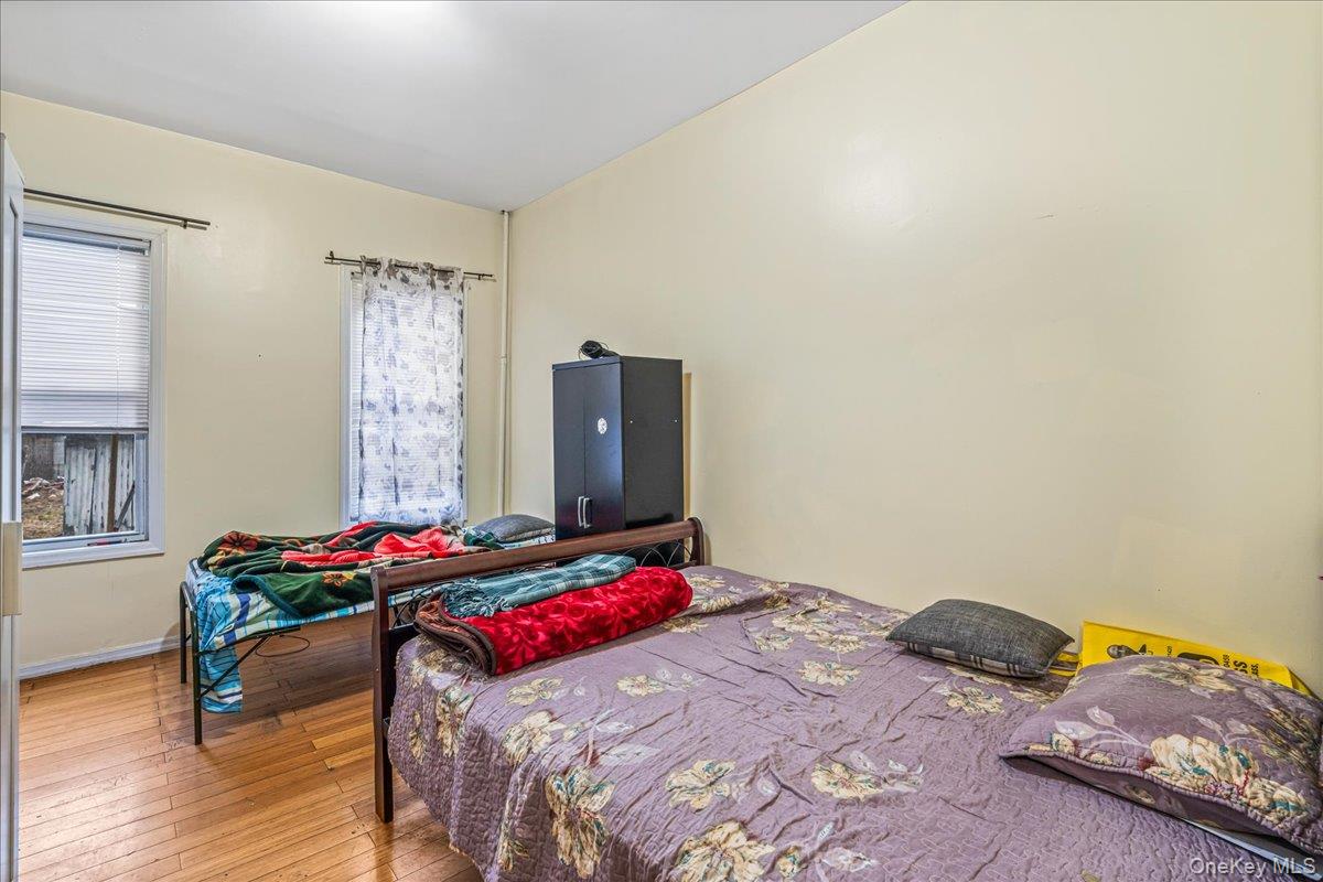 89-21 129th Street Queens, NY 11418 - Photo 9 of 19 a bedroom with a bed and dresser