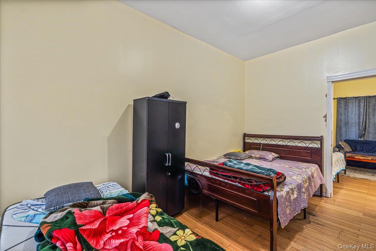 89-21 129th Street Queens, NY 11418 - Photo 10 of 19 a bedroom with a bed and a dresser