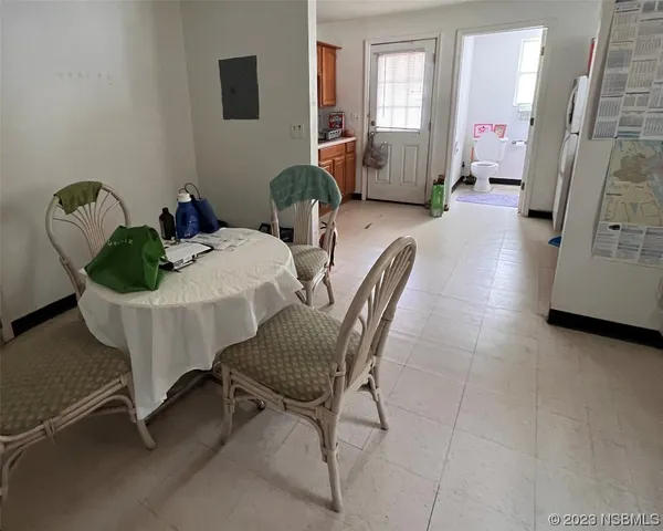 a living room with furniture and a mirror