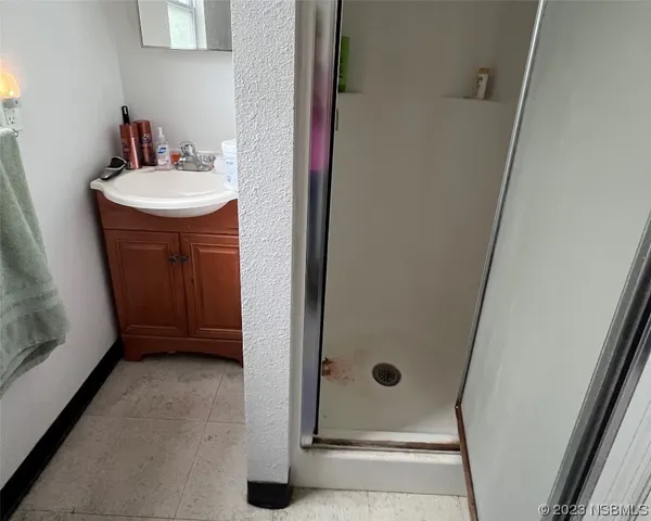 a bathroom with a sink a mirror and shower