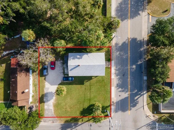 an aerial view of a house with a yard and garden