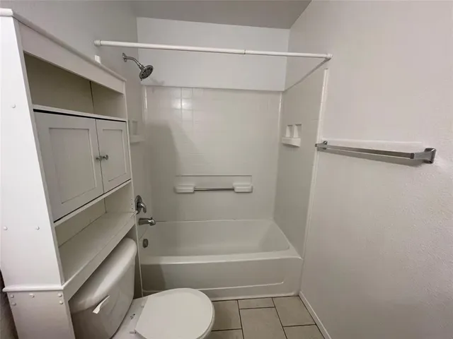 a bathroom with a shower and a toilet