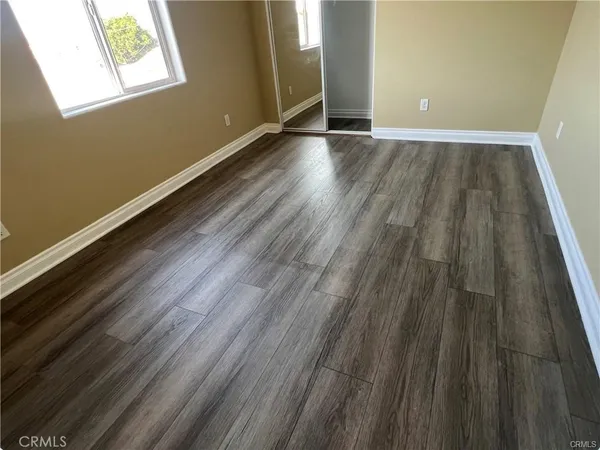 a view of room with window and wooden floor