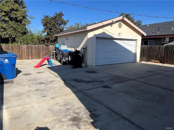a view of a backyard with a small cabin and wooden fence