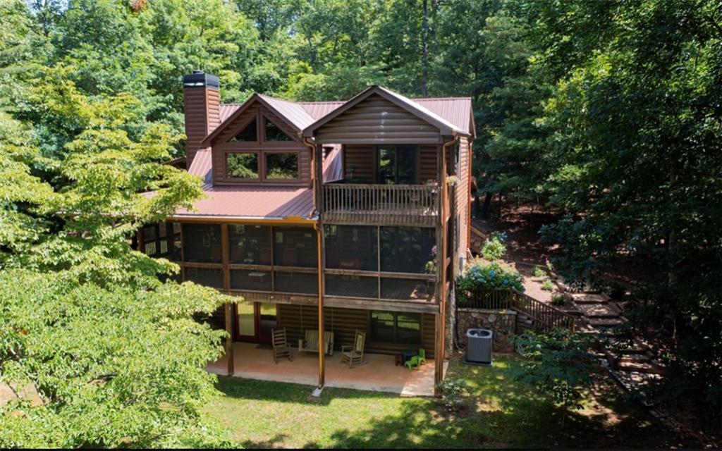 578 Garrett Branch Road Ellijay, GA 30536 - Photo 1 of 1 a front view of a house with a garden