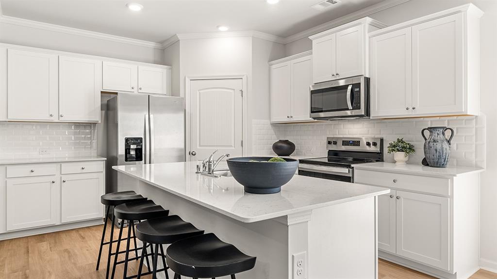 3574 Matthew Court Decatur, GA 30030 - Photo 4 of 18 a kitchen with stainless steel appliances a stove a sink a microwave and cabinets