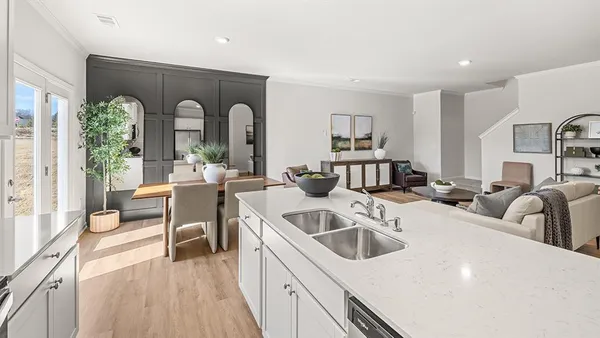 a view of a kitchen with a sink and living room