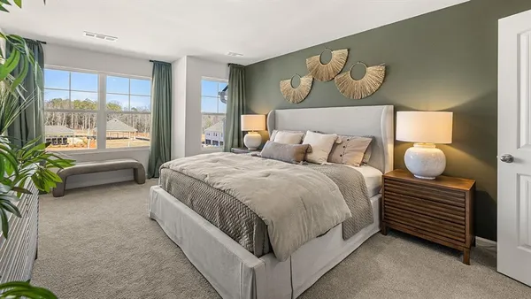 a spacious bedroom with a bed and a large window