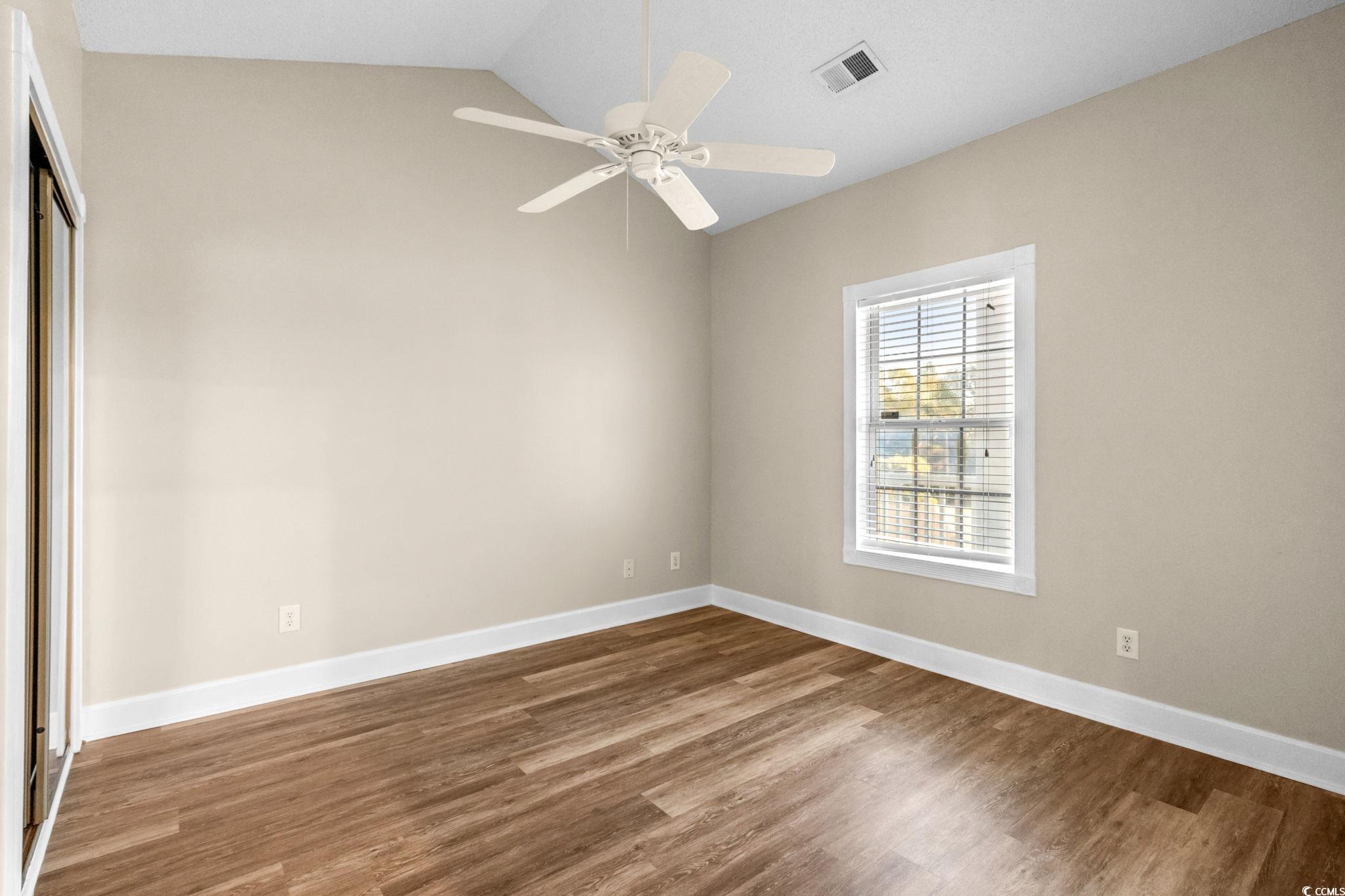 4815 Orchid Way, Unit 302 Myrtle Beach, SC 29577 - Photo 14 of 26 Spare room with wood finished floors, lofted ceiling, and ceiling fan
