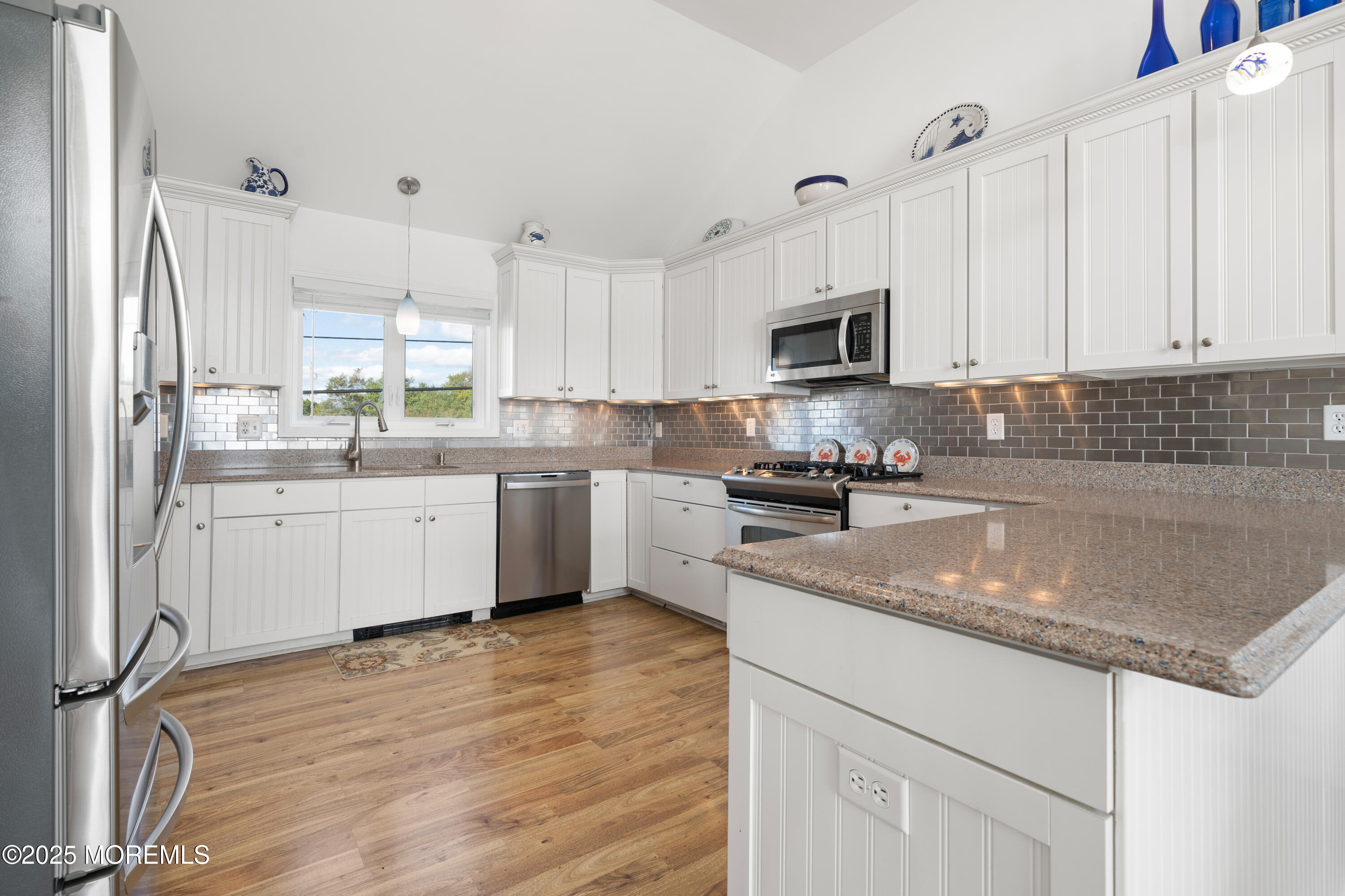 76 Sheridan Street Waretown, NJ 08758 - Photo 15 of 51 a kitchen with stainless steel appliances granite countertop a sink a stove a refrigerator a microwave and cabinets