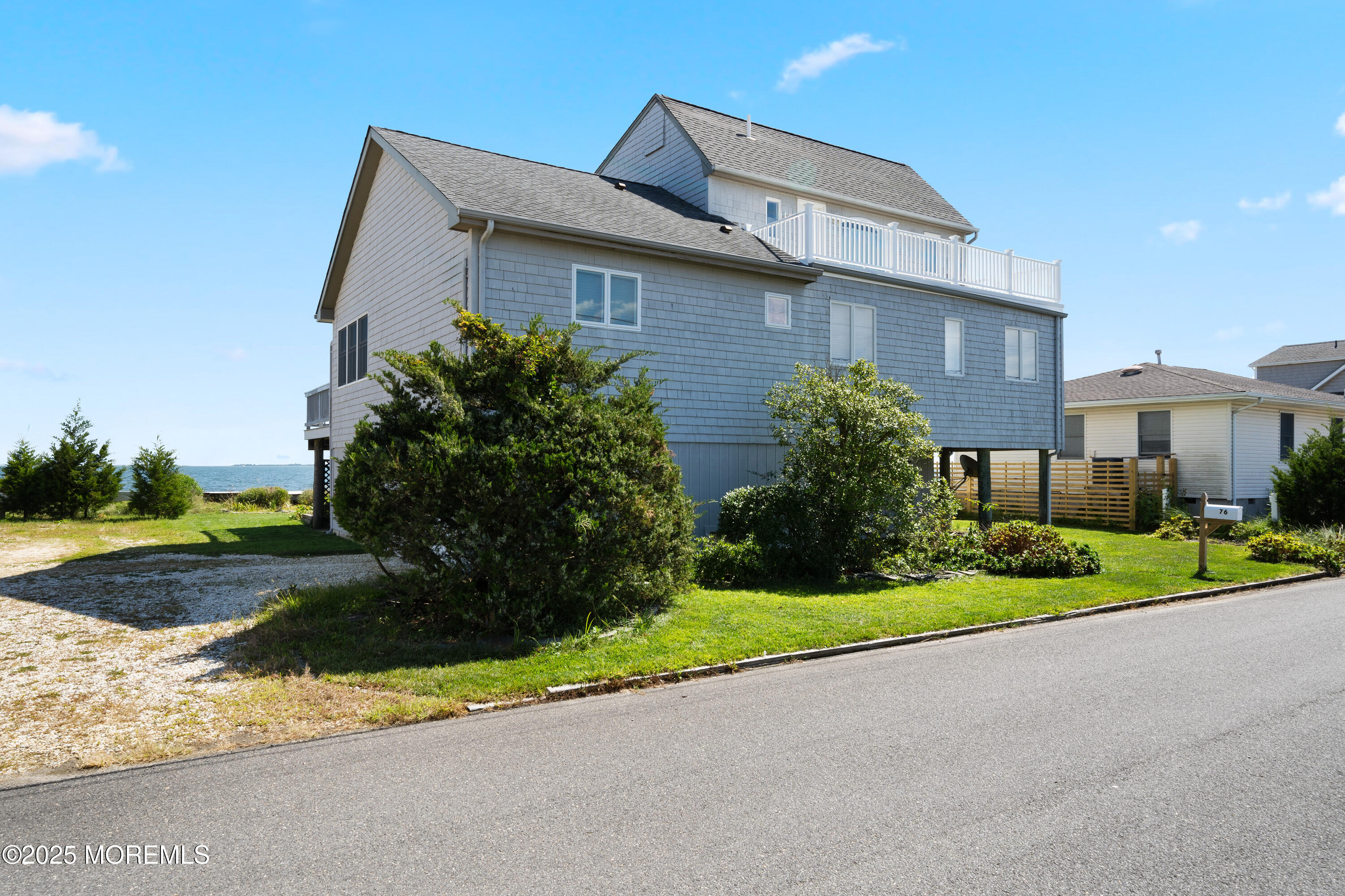 76 Sheridan Street Waretown, NJ 08758 - Photo 5 of 51 a front view of a house with a yard and garage