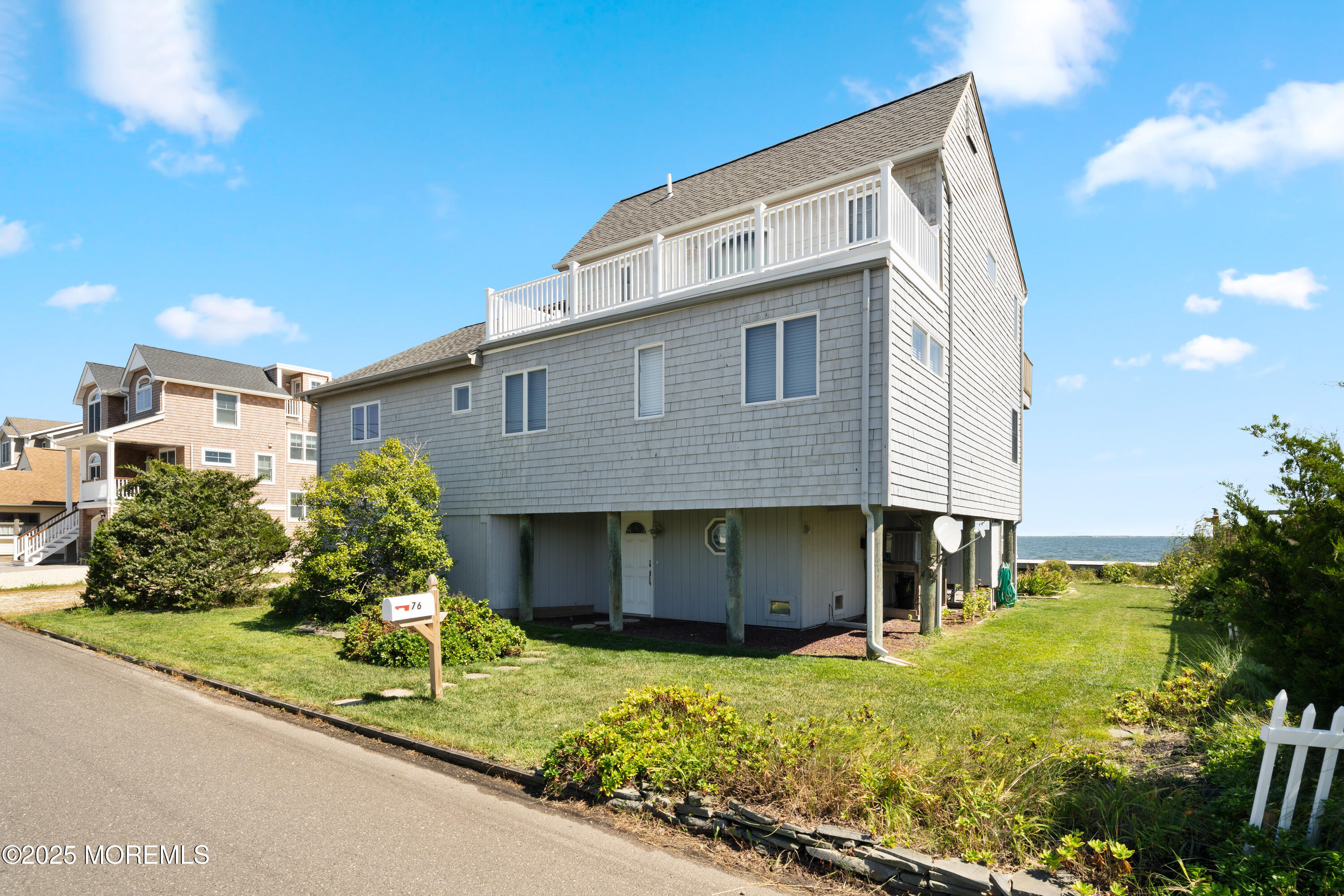 76 Sheridan Street Waretown, NJ 08758 - Photo 6 of 51 a front view of a house with a yard