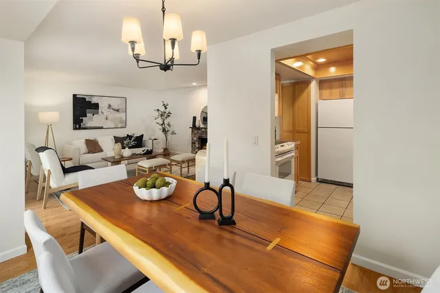 a view of a dining room with furniture a chandelier and wooden floor