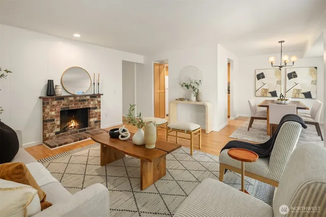 a living room with furniture a fireplace and a table