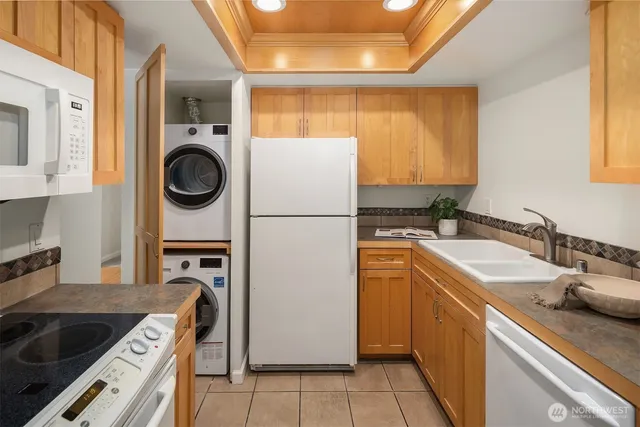 a kitchen with a sink a stove top oven and refrigerator