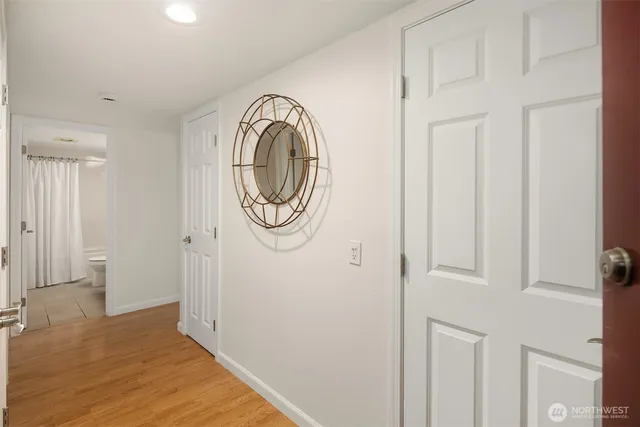 a view of a hallway with wooden floor