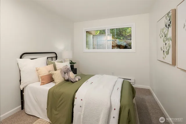 a bedroom with a bed and a painting on the wall