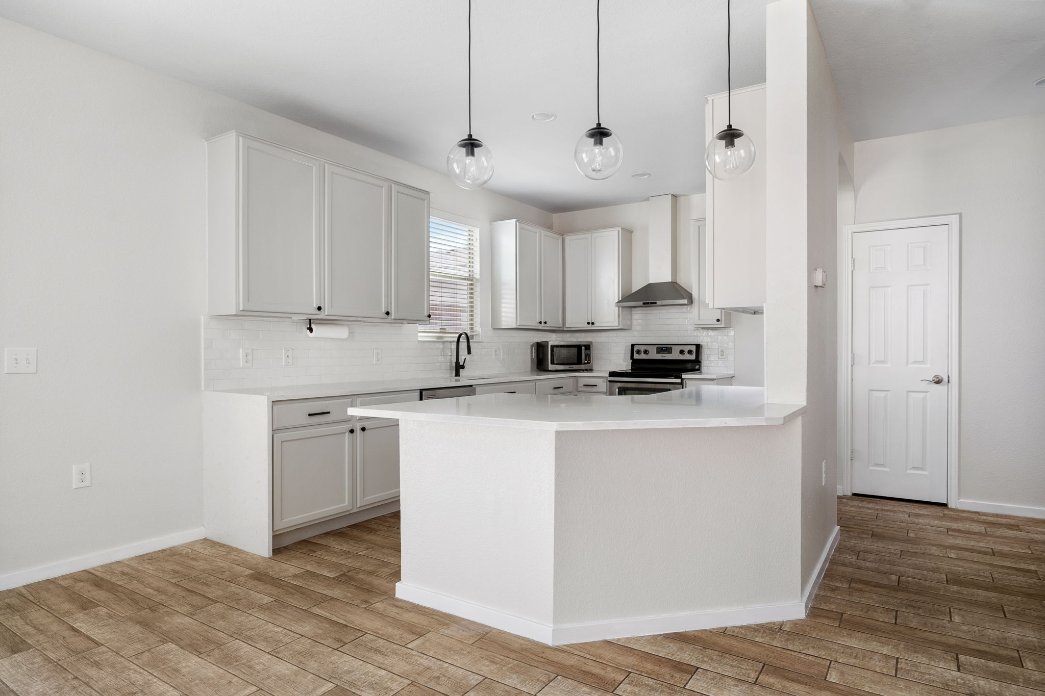 8909 Winter Haven Road Austin, TX 78747 - Photo 11 of 37 a kitchen with stainless steel appliances granite countertop a sink a stove a refrigerator and white cabinets
