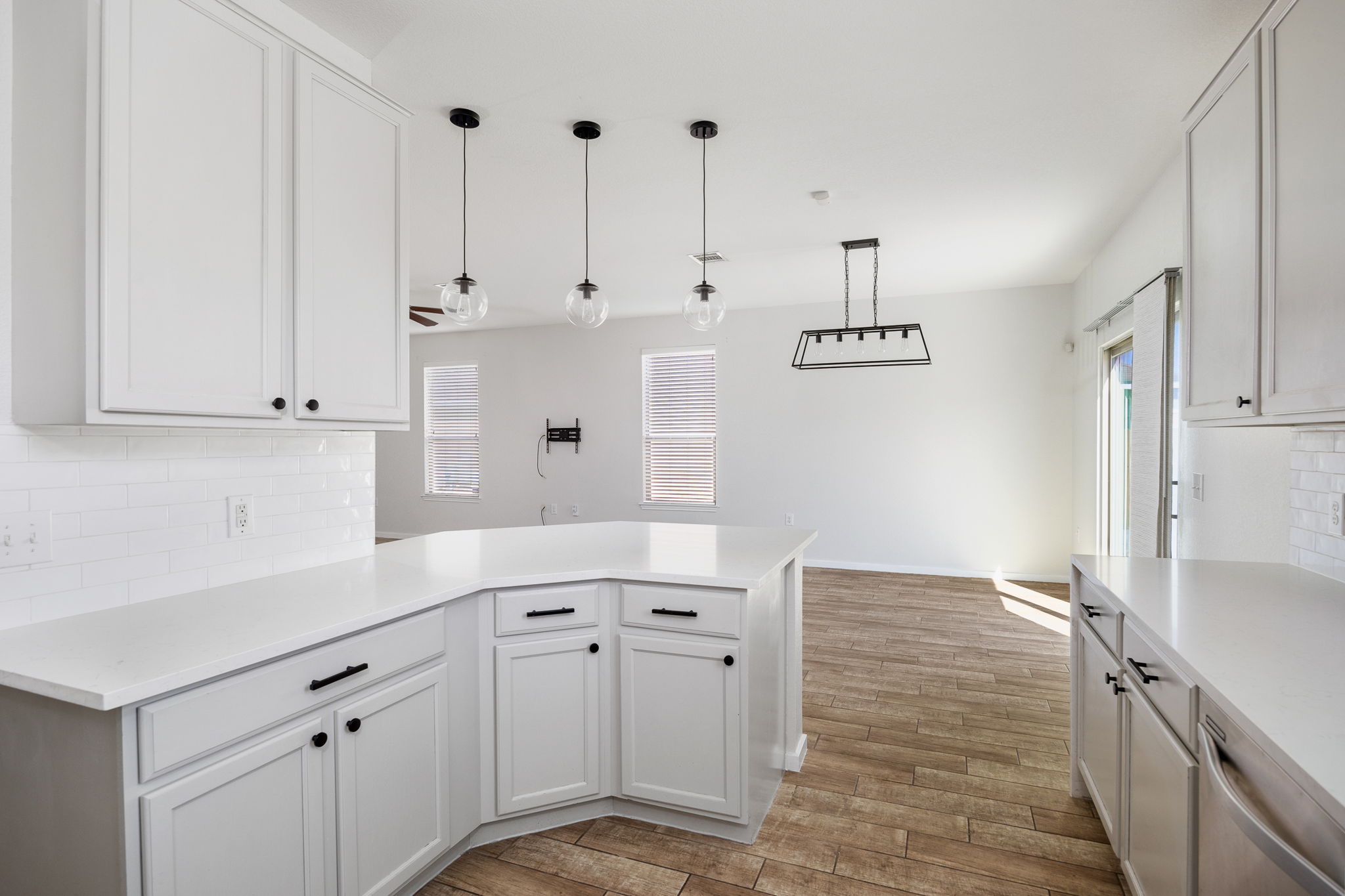 8909 Winter Haven Road Austin, TX 78747 - Photo 12 of 37 a kitchen with granite countertop white cabinets and white appliances