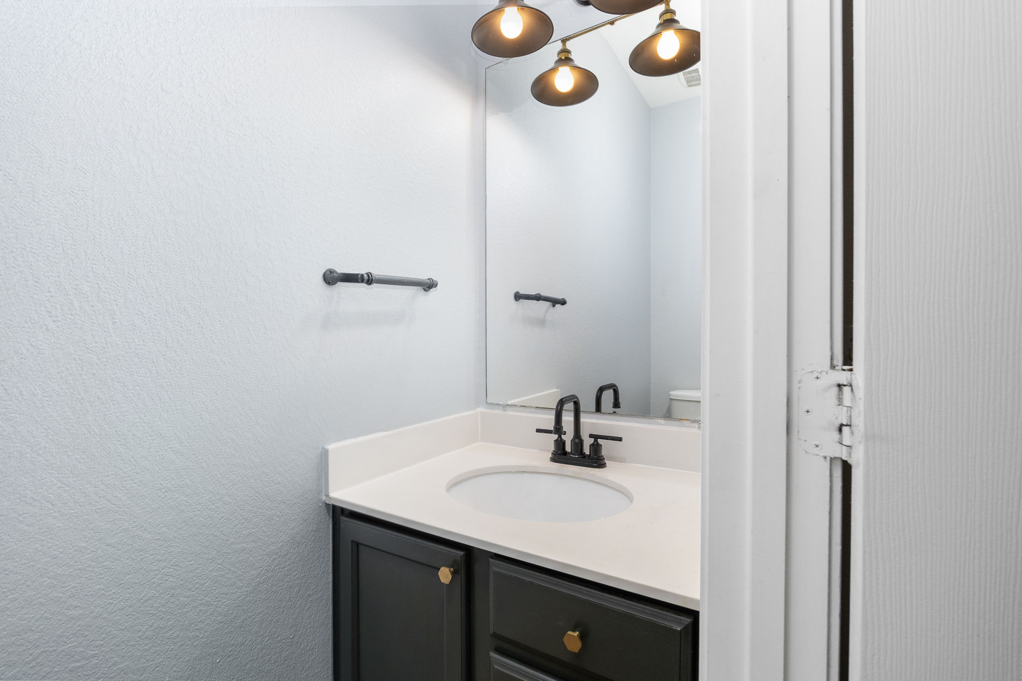 8909 Winter Haven Road Austin, TX 78747 - Photo 18 of 37 a bathroom with a sink and a mirror
