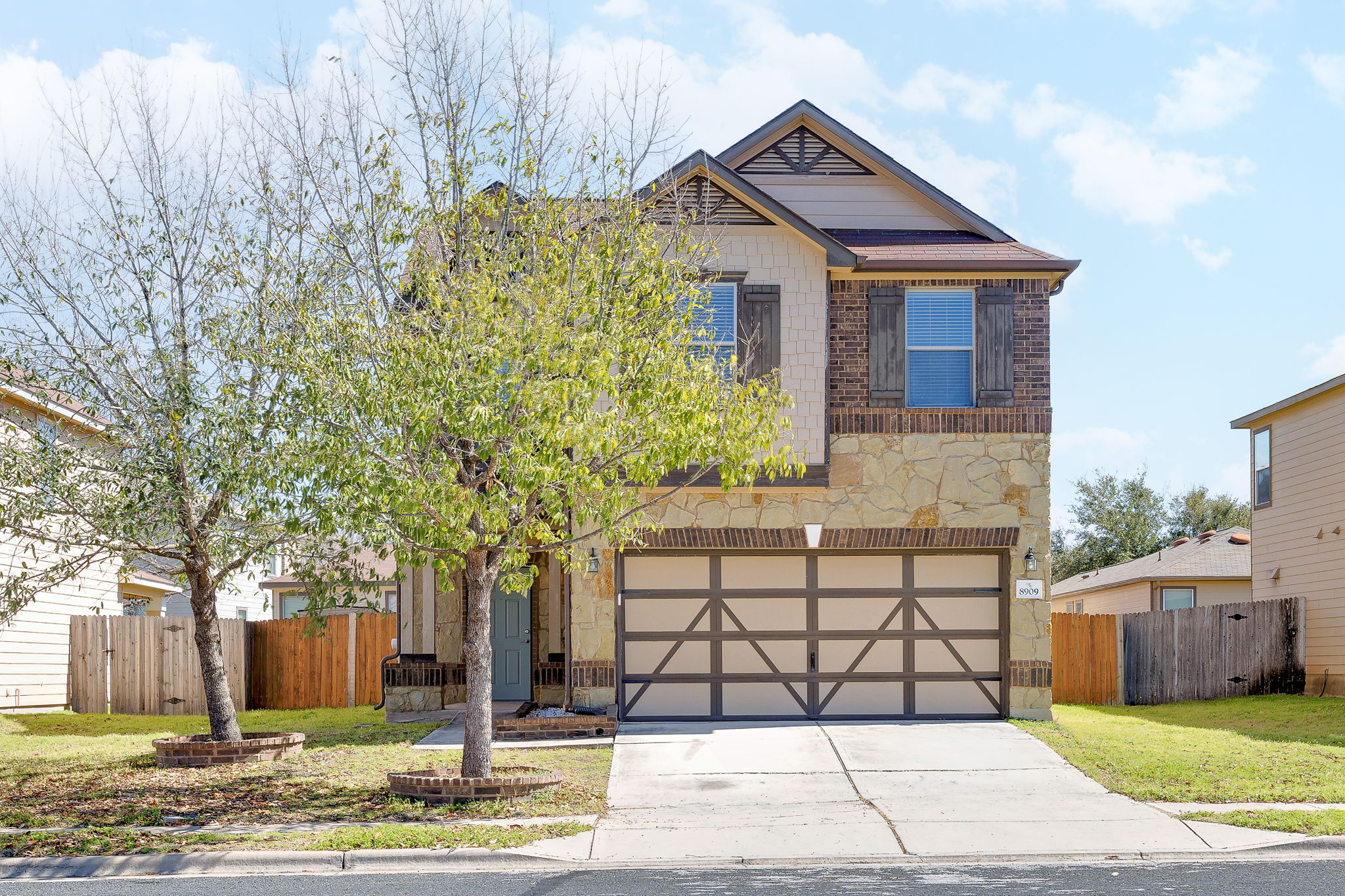 8909 Winter Haven Road Austin, TX 78747 - Photo 2 of 37 a front view of a house with a garden