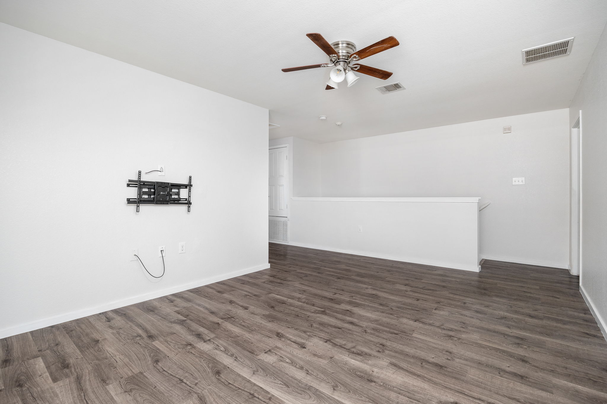 8909 Winter Haven Road Austin, TX 78747 - Photo 23 of 37 an empty room with wooden floor and windows