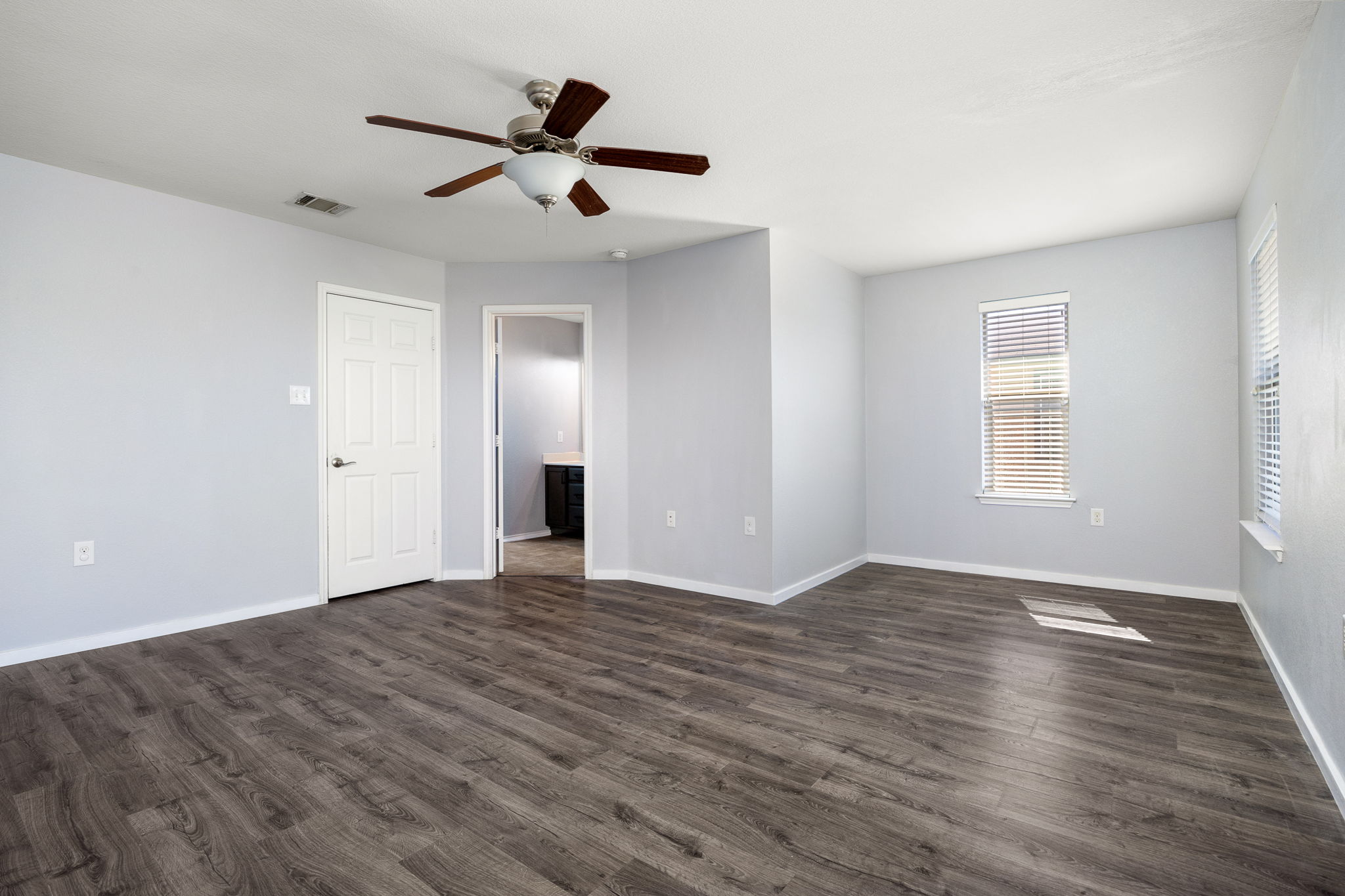 8909 Winter Haven Road Austin, TX 78747 - Photo 26 of 37 a view of an empty room with wooden floor and a window