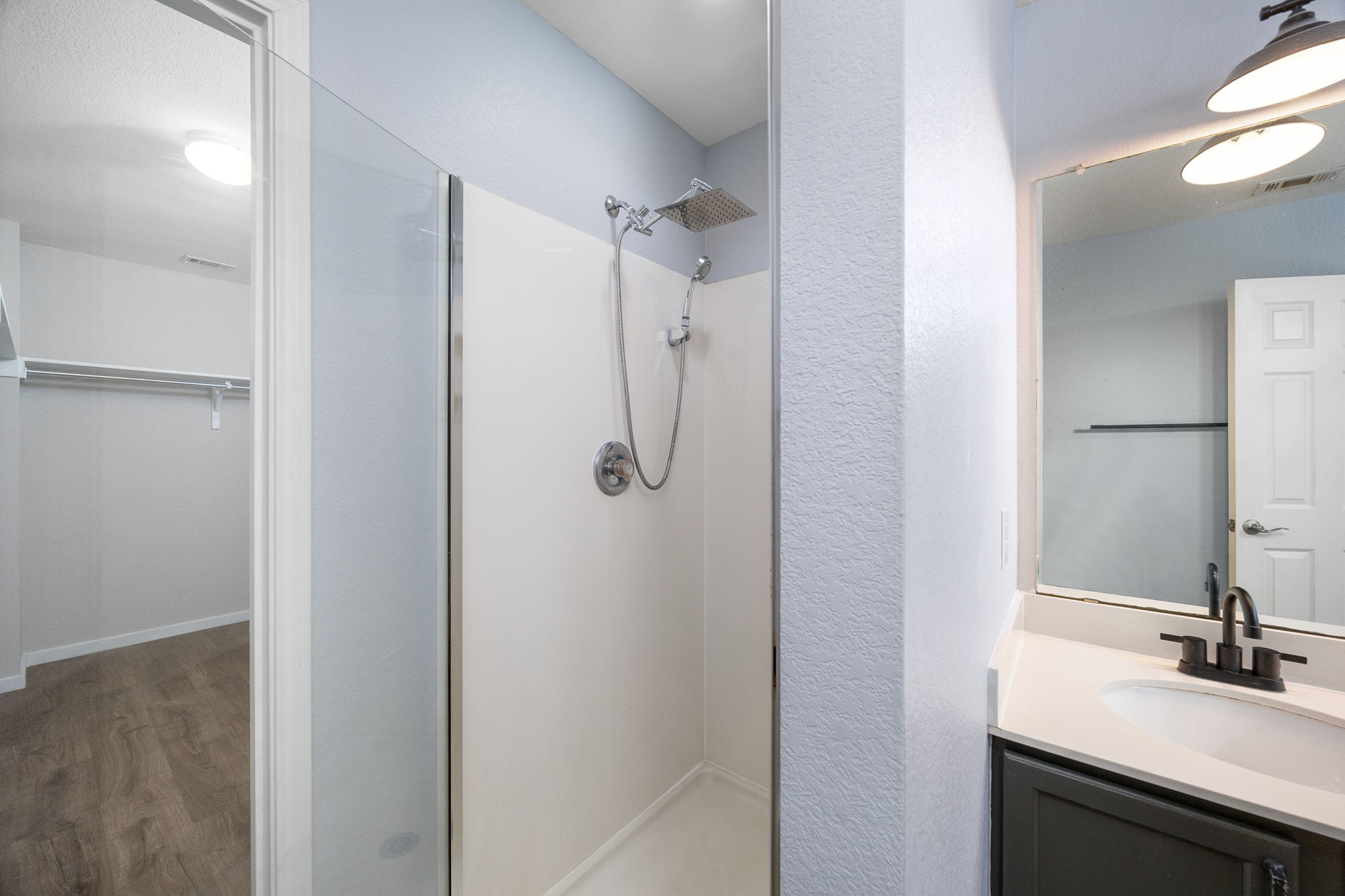 8909 Winter Haven Road Austin, TX 78747 - Photo 31 of 37 a bathroom with a shower sink and mirror