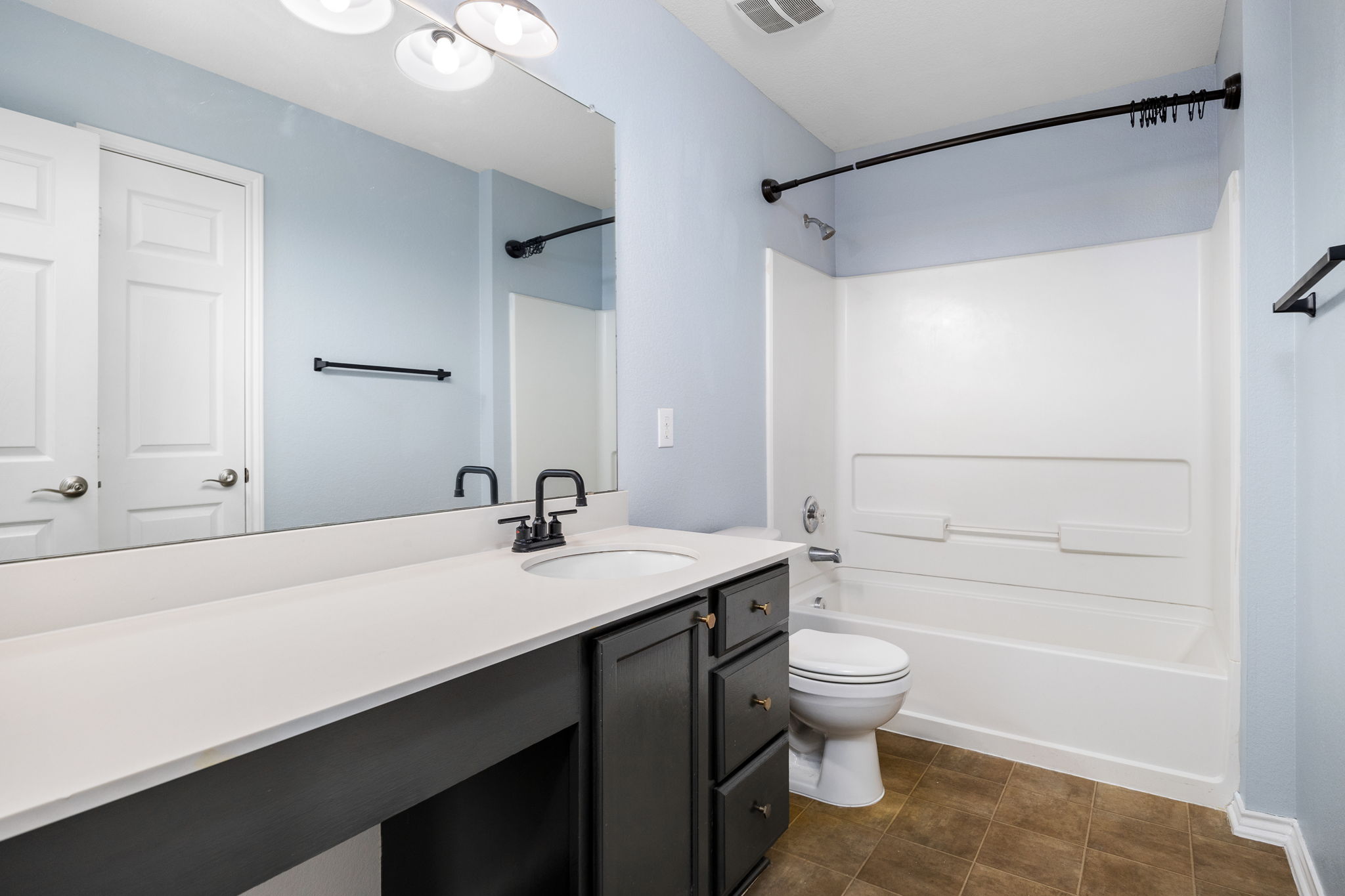 8909 Winter Haven Road Austin, TX 78747 - Photo 35 of 37 a bathroom with a sink a toilet and shower