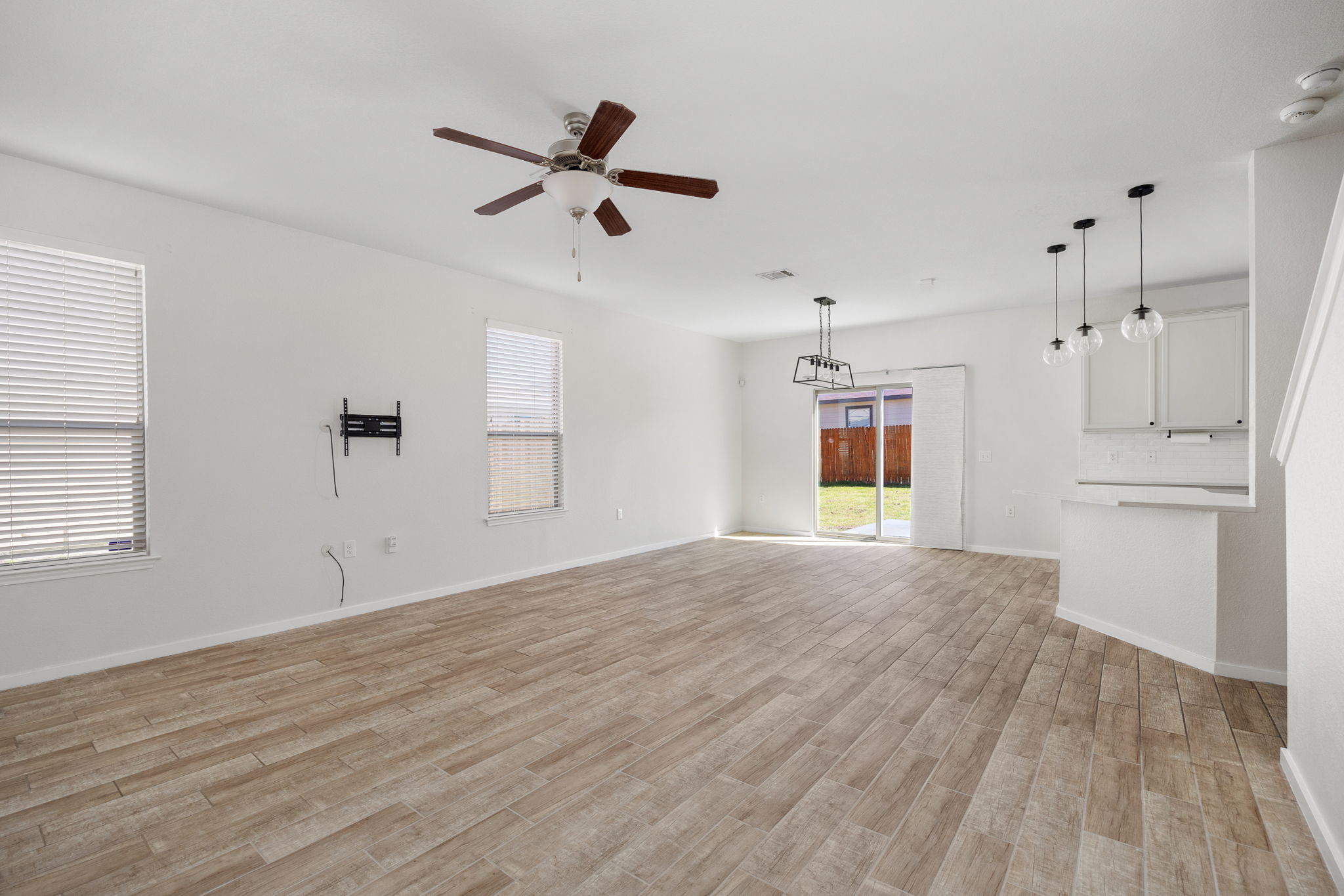 8909 Winter Haven Road Austin, TX 78747 - Photo 5 of 37 a view of empty room with wooden floor and window