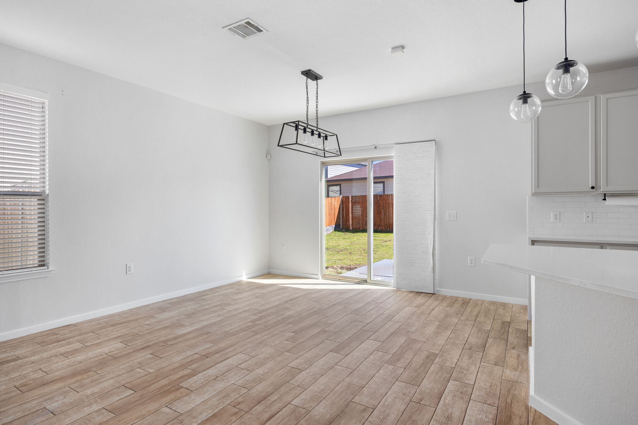 8909 Winter Haven Road Austin, TX 78747 - Photo 6 of 37 a view of a room with window wooden floor and a chandelier