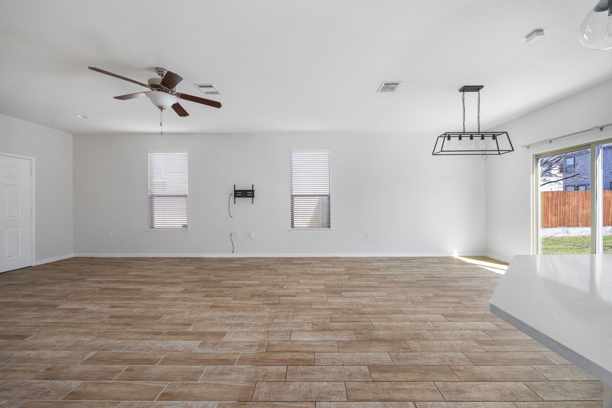 8909 Winter Haven Road Austin, TX 78747 - Photo 7 of 37 a view of empty room with wooden floor and ceiling fan