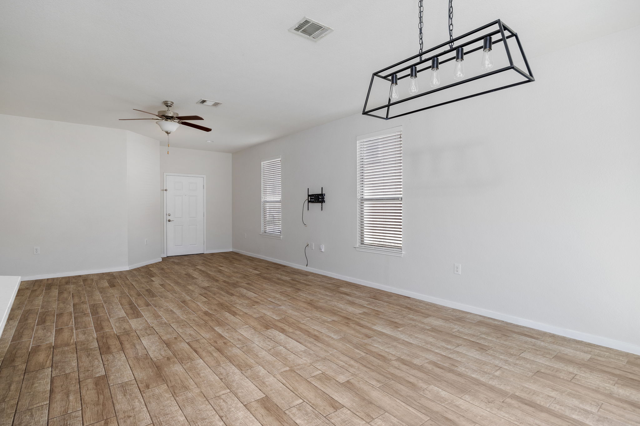 8909 Winter Haven Road Austin, TX 78747 - Photo 8 of 37 a view of a room with wooden floor and ceiling fan