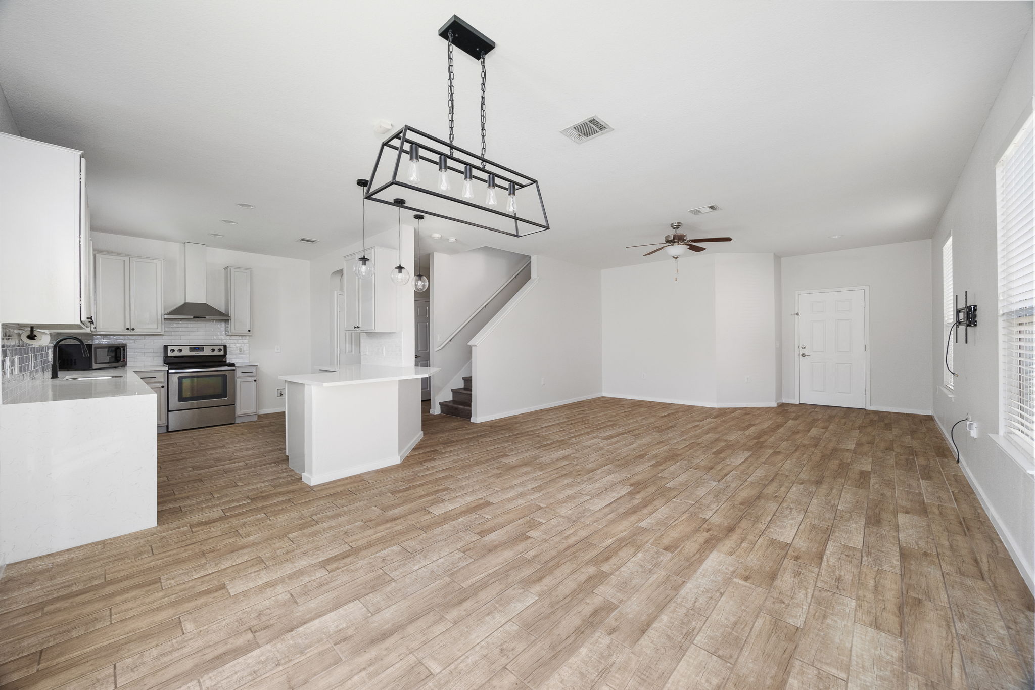 8909 Winter Haven Road Austin, TX 78747 - Photo 9 of 37 a view of empty room with kitchen view and appliances