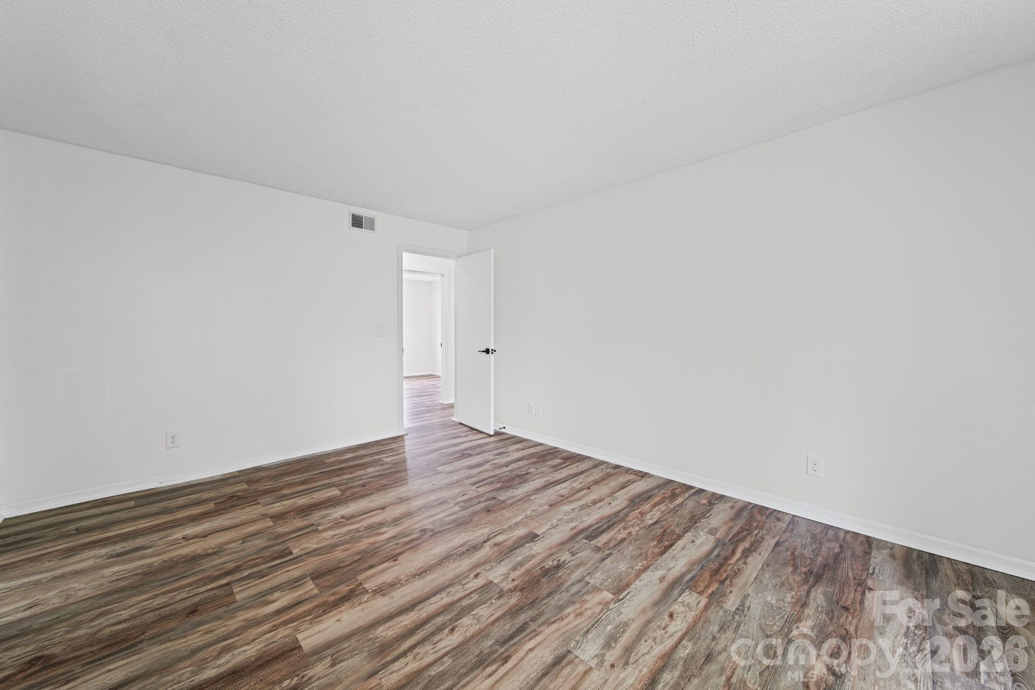 11023 Harrowfield Road Charlotte, NC 28226 - Photo 21 of 32 a view of an empty room with wooden floor