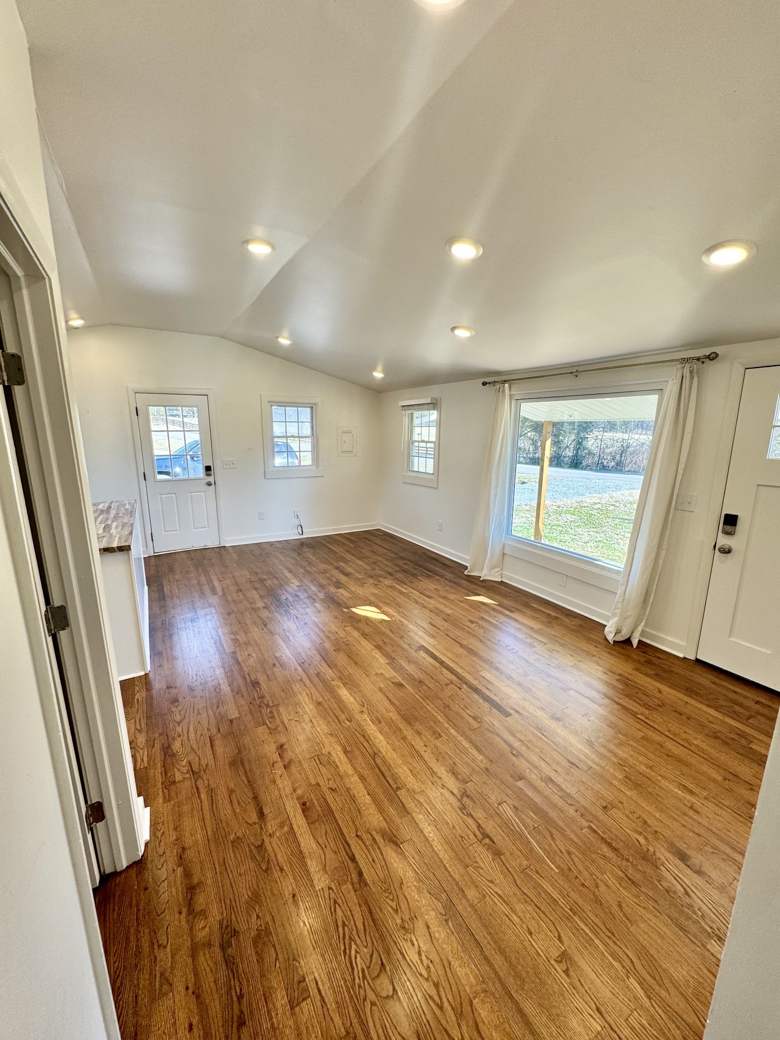 8649 Taliaferro Road Eagleville, TN 37060 - Photo 18 of 24 an empty room with wooden floor and windows