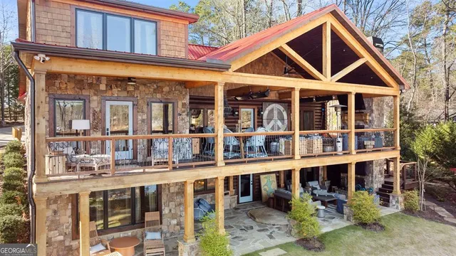 a living room with furniture a large window and wooden floor