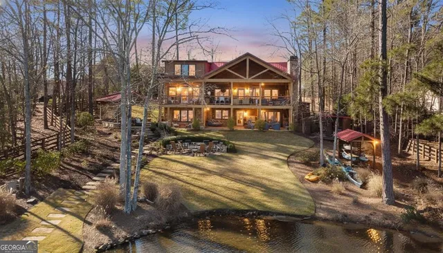 an aerial view of a house with a lake view