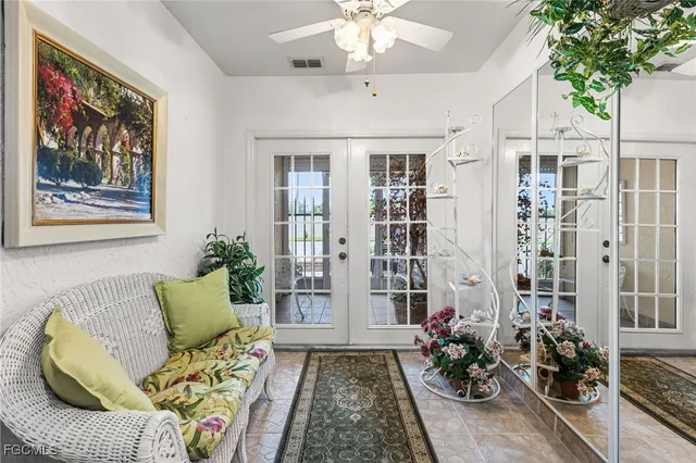 a living room with furniture and a potted plant